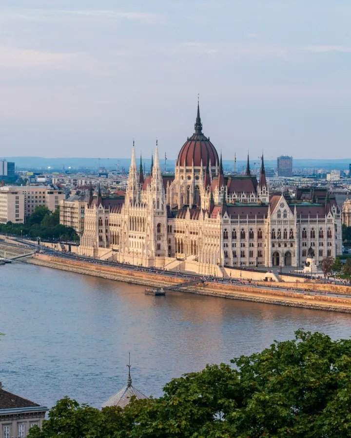 A river cruise ship sailing through a historic European city.
