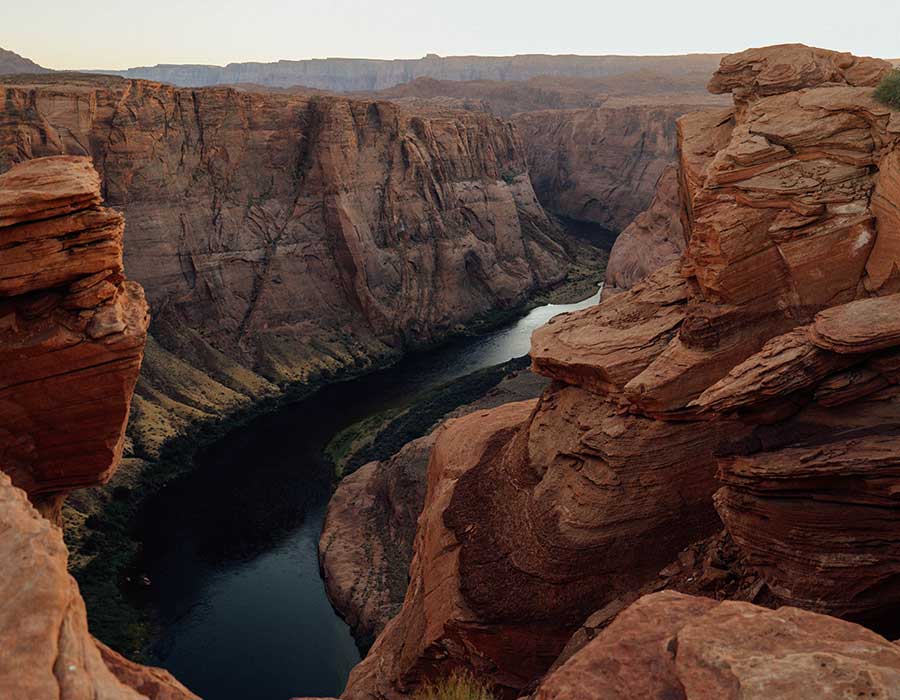 Breathtaking view of the Colorado River winding through Horseshoe Bend's dramatic red rock canyon in Arizona.