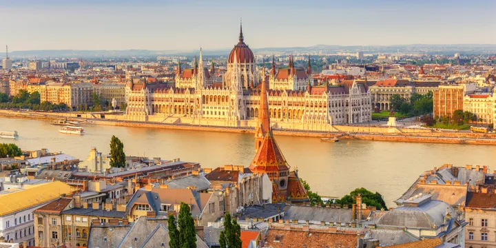 Stunning view of the Hungarian Parliament Building and Danube River in Budapest at sunset.